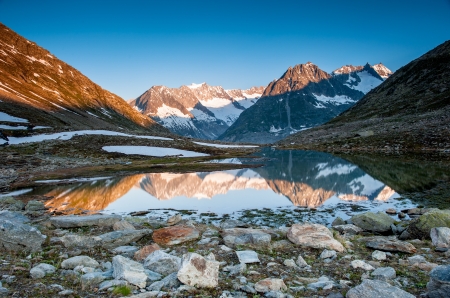 Mountain panorama from Maerjelensee in early morning with Fusshorn and Dreieckshorn. Part of the Jungfrau-Aletsch UNESCO World Heritage, Wallis, Switzerland.の写真素材