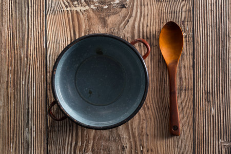 Spoon with empty cooker on a tableの写真素材