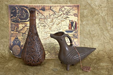 Still life with jug and old map