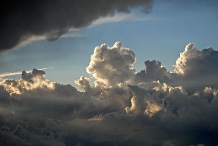 Above clouds. Sun shines through clouds
