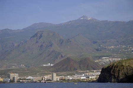 City Los Cristianos in Tenerife island, Canary Islands. In the background - Volcano El Teide. El Teide, a volcano on Tenerife is the highest mountain of Spain 12,188.3 feet (3,715 m)の写真素材