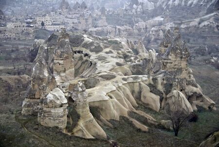 Sandstone formations in Cappadocia, Turkey. At the background - town Goreme.の写真素材