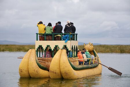 People are sitting in reed boat at lake Titicaca.の写真素材