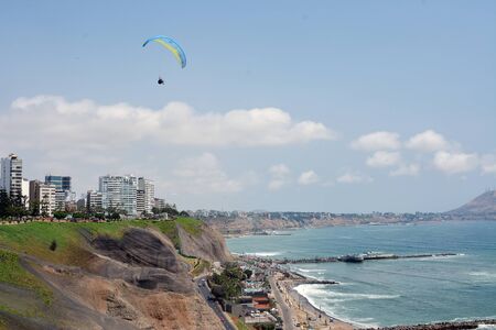 Paragliding over the steep coastline of Miraflores in Lima, Peru.