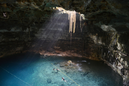 People swimming in Samula cenote.This cenote is located 7 km from center of town Valladolid in...