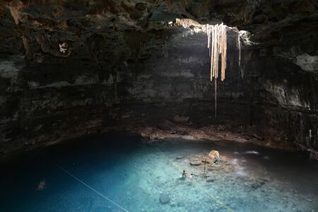 People swimming in Samula cenote.This cenote is located 7 km from center of town Valladolid in Yucatan peninsula, Mexico.の写真素材