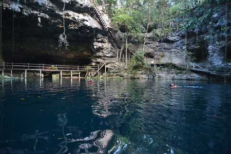 Swimmeres in X-Canche cenote in Yucatan peninsula, Mexico.This cenote is 30 km from center of town Valladolid near Mayan site Ek Balam. Yucatan peninsula, Mexico.のeditorial素材