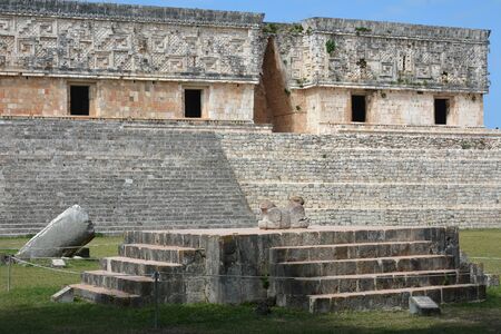 Jaguar throne and Governor's Palace in the foreground. Uxmal, Yucatan Peninsula, Mexico.The...