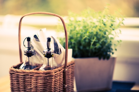 Herbs, Olive Oil and Other Eating Accessories in the Wicker Basket.