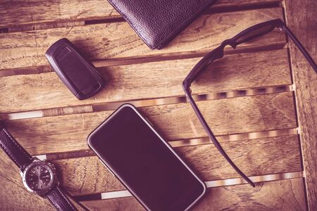 Everyday Man Tools. Smartphone, Car Keys, Glasses and Wallet on the Table.の写真素材