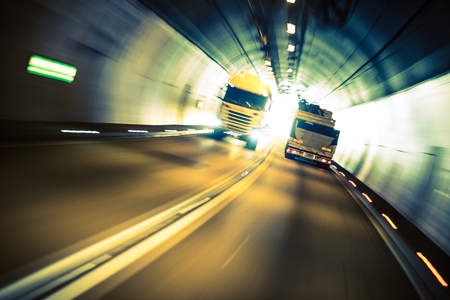 Speeding Trucks in the Tunnel. Trucking Road Transportation.の写真素材