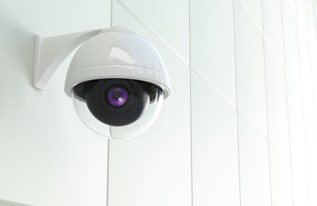 Modern CCTV Network Camera Mounted to the White Modern Wall. Closed Circuit Television Theme. 3D Rendered Illustration.の写真素材