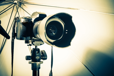 Modern Digital Photo Camera in the Photography Studio Closeup Photo.