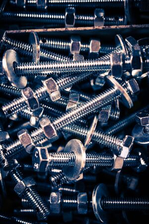 Stainless Steel Screws Closeup Vertical Photo.
