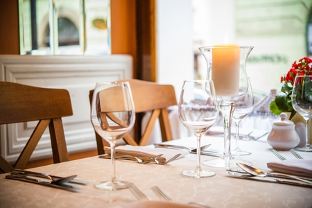 Romantic Dinner Table with Burning Candle Closeup Photo.