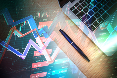 Technology, money and investment concept - laptop computer and forex chart on wood tableの写真素材