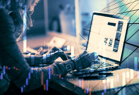Forex. money, technology, business concept. Business woman sitting in front of a computer.の写真素材