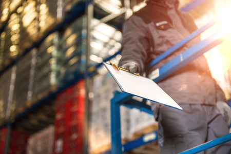 Warehouse worker giving raports closeup photo.の写真素材