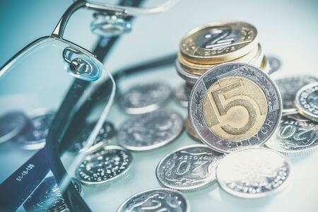 Polish Currency Coins and Glasses. Five Zloty Coins Closeup Photo.の写真素材