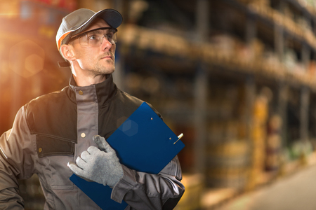 Caucasian warehouse worker with clipboard.の写真素材