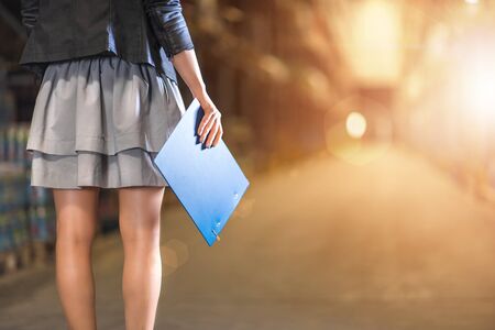 Business woman with clipboard standing in warehouse. Closeup photo.の写真素材