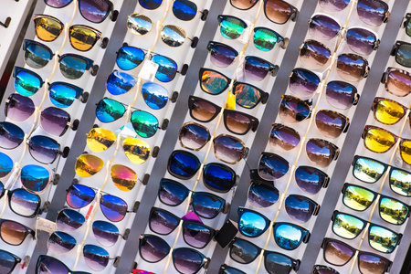 A Street Stand with Different Kinds of Sunglasses. Local Shop in Tourist Town. Summer and Vacation Accessories Sale.の写真素材
