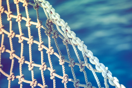 Closeup of Decorative Sea Net Mounted on a Tourist Boat. Clean Blue Water in the Background. Tourism Industry Theme. Concept Marine Background.の写真素材
