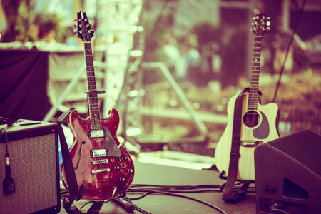 Classical and Electric Guitars on Concert Stage Before the Start of Musical Performance. Music and Entertainment Theme.の写真素材