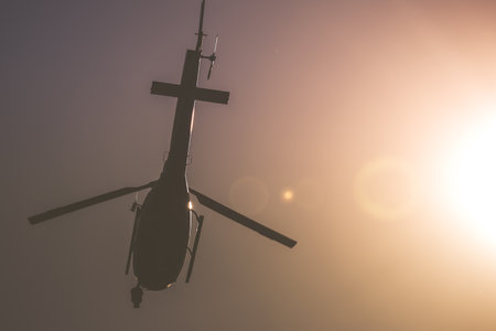 Helicopter Flying in the Sky Under the Shining Sun. Rotorcraft Machine in the Air Closeup....