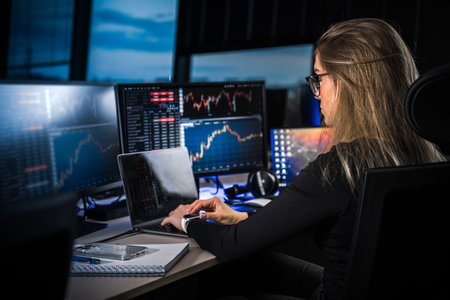 Cryptocurrency stock market female trader. Cryptocurrency professional trader. night work. Working late. computer screens.の写真素材
