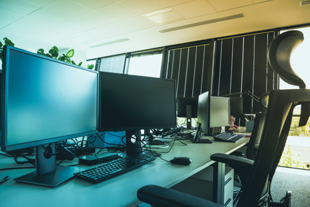 Desk with computer and monitors in the office. developer. Corporate open space office.