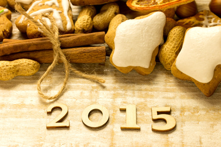 2015 gingerbread, cinnamon and nuts on a wooden surfaceの写真素材