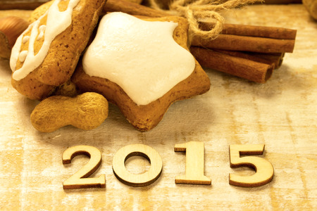 New Year 2015 from wooden letters on a rustic table with gingerbread cookies and cinnamonの写真素材