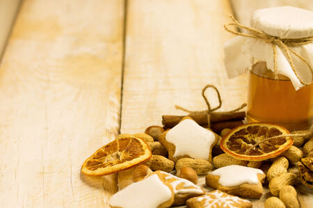 honey cookies with nuts,orange and cinnamon on a wooden surfaceの写真素材