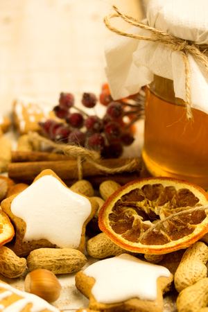 honey cookies with nuts and orange and honey on a tableの写真素材