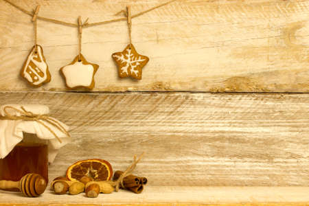 Gingerbread cookies hanging over wooden backgroundの写真素材