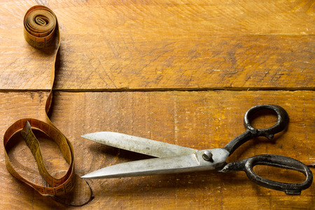 Old tailors scissors and metric on wood backgroundの写真素材