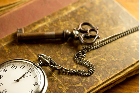 old key,pocket watch and old bookの写真素材