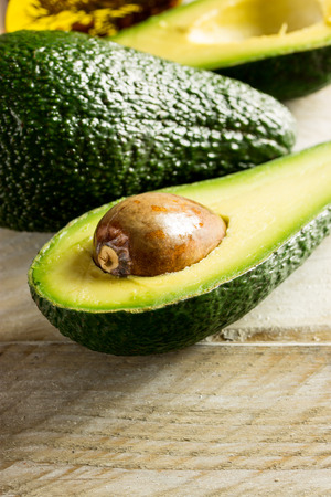 Fresh avocado over a wooden backgroundの写真素材
