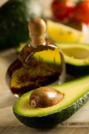 Bottle of avocado essential oil with fresh avocado fruit closeupの写真素材