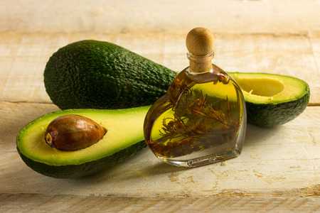 Bottle of avocado essential oil with fresh avocado fruit closeupの写真素材