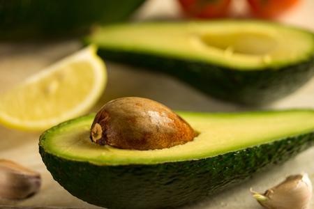 Fresh avocado on cutting board over wooden backgroundの写真素材