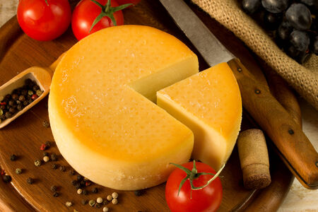 Cheese wheel on a wooden cutting board