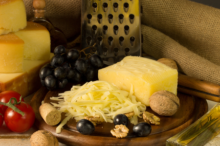 Different types of cheese over old wooden table.の写真素材