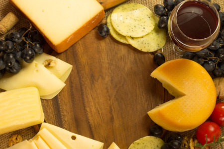Red Wine And Assorted Cheese Plate with fruitの写真素材