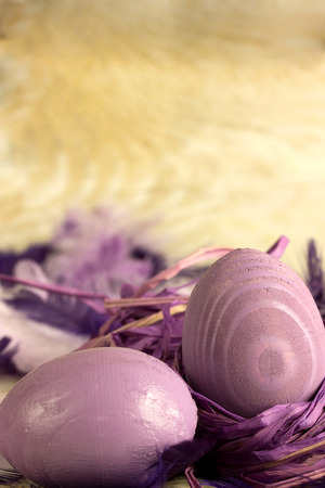 purple easter eggs over a wooden backgroundの写真素材