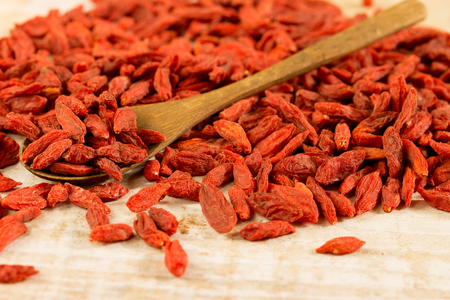Goji berries on a wooden spoon closeupの写真素材