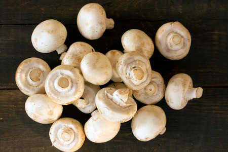 mushrooms over a brown wooden backgroundの写真素材