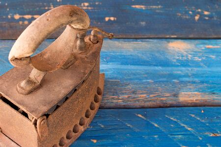 old vintage iron on a blue wooden backgroundの写真素材
