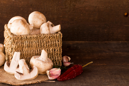 fresh mushroom in a handmade rustic box,over a dark wooden backgroundの写真素材